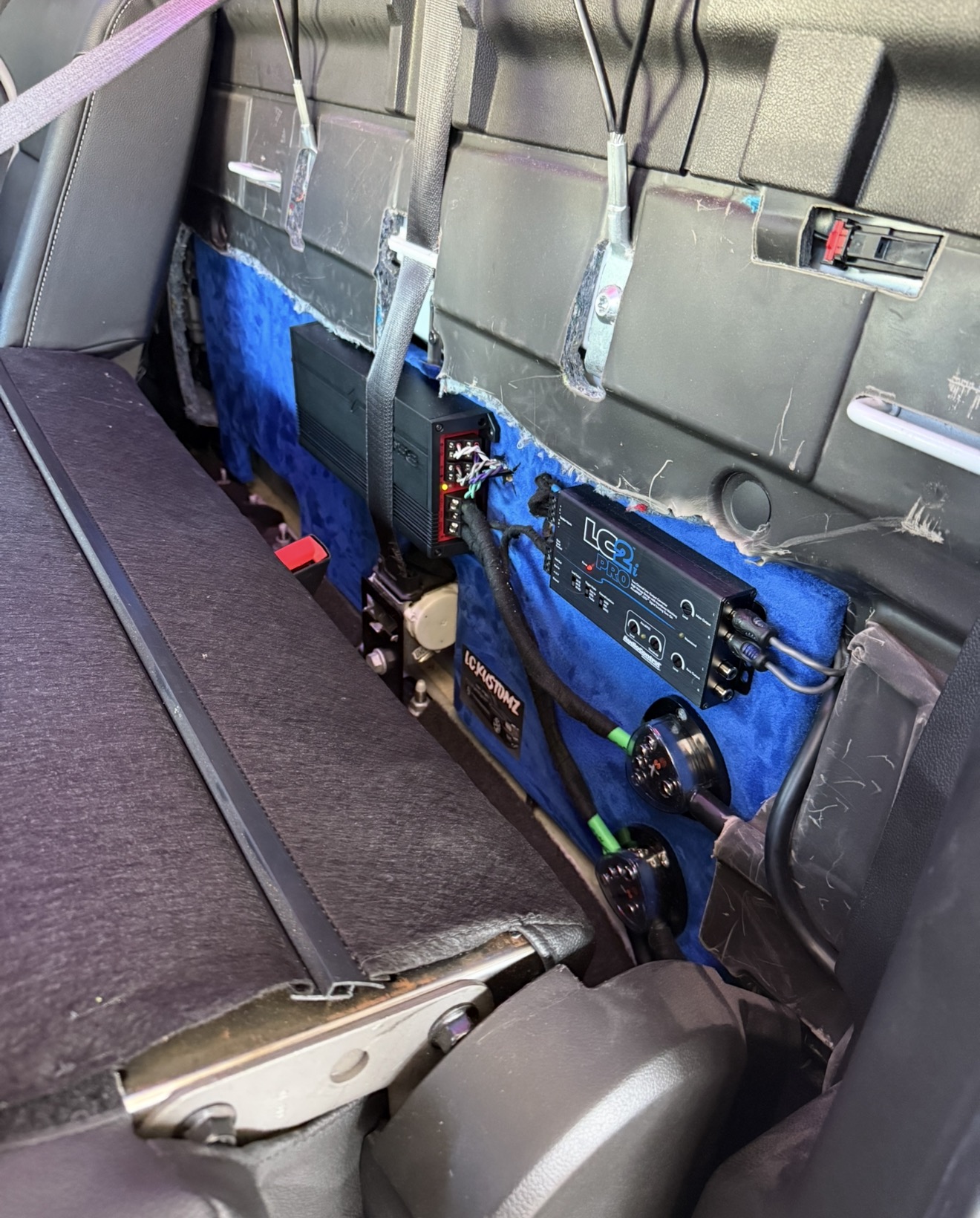 Hidden amplifier and LC2i Pro line output converter install behind the rear seat