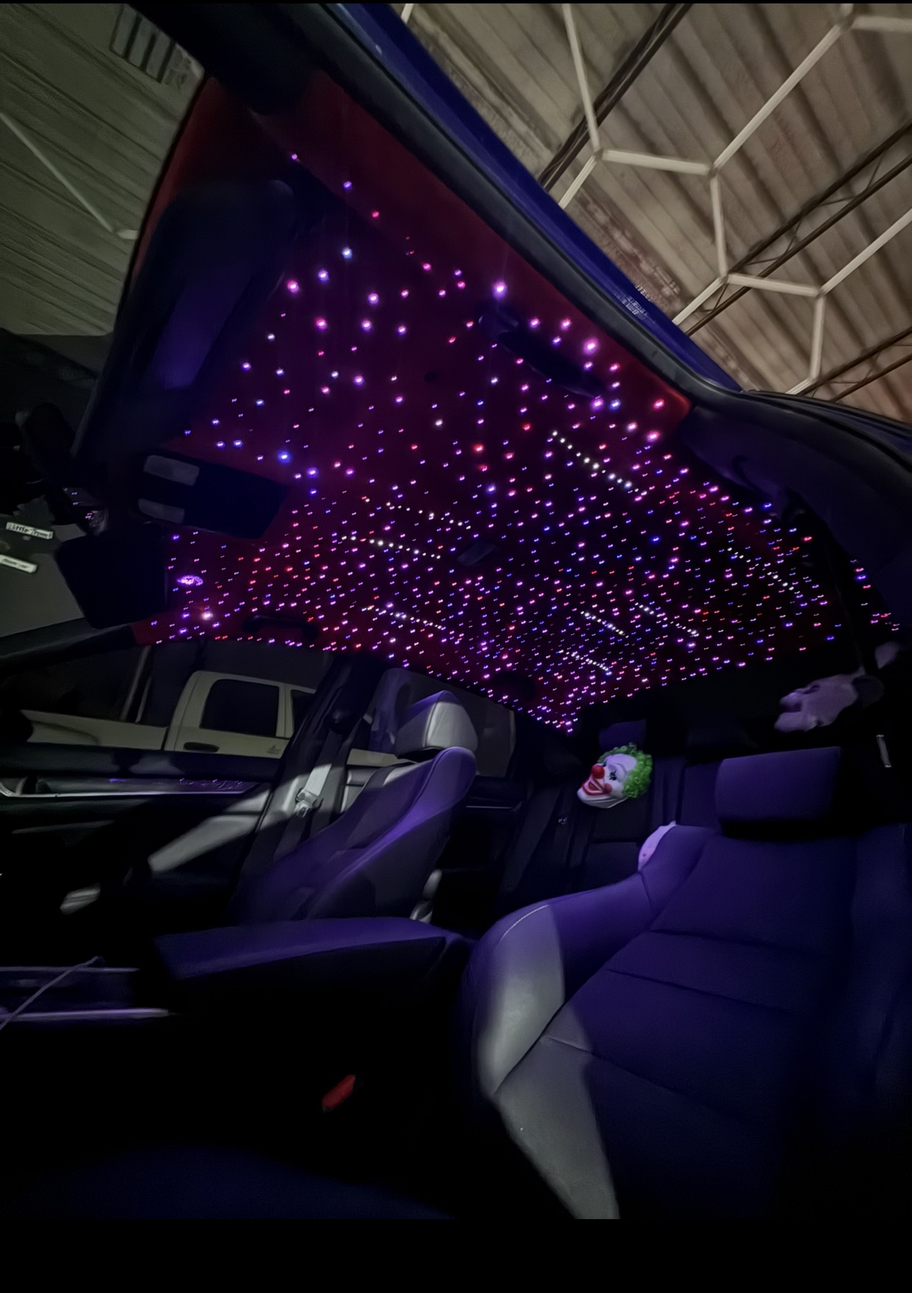 Sedan interior with dense pink and purple fiber-optic starlight headliner