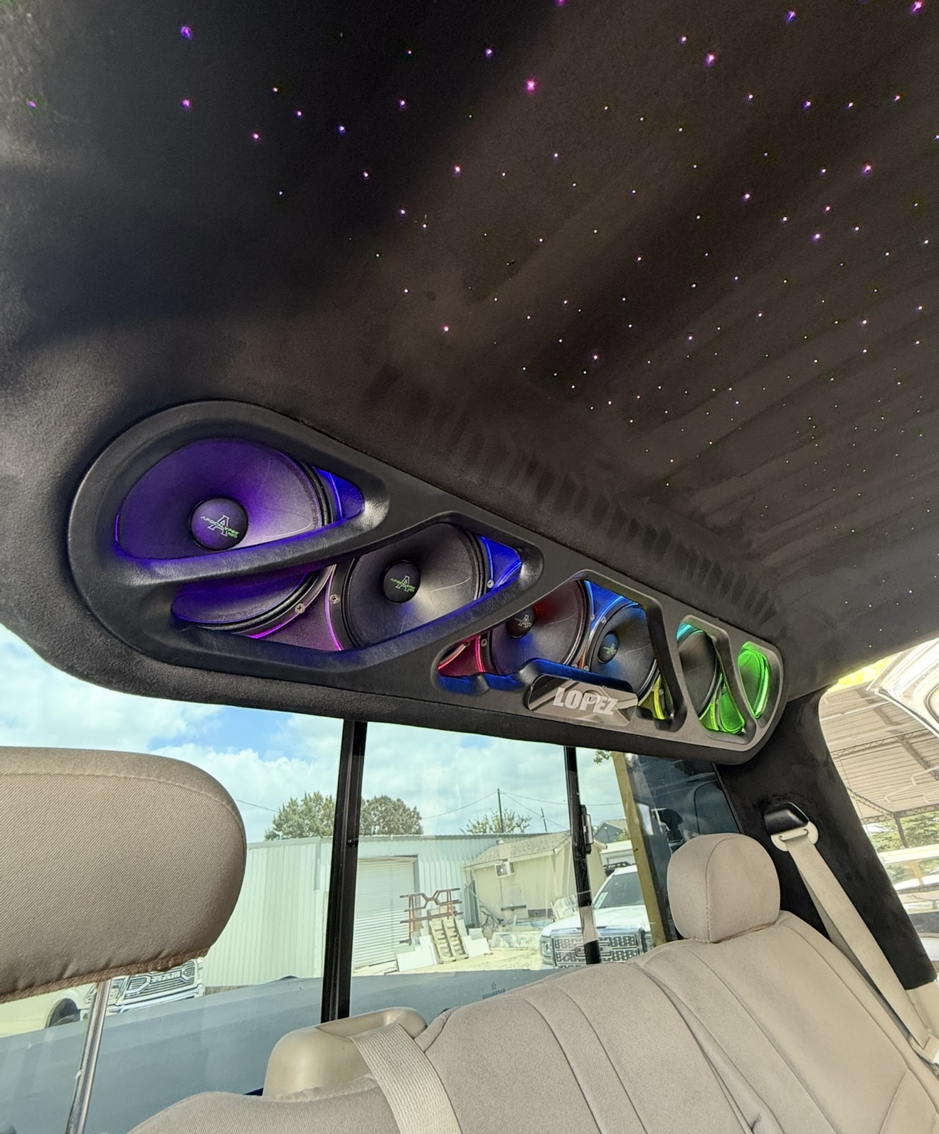 Custom overhead speaker pods with multicolor RGB lighting and starlight headliner