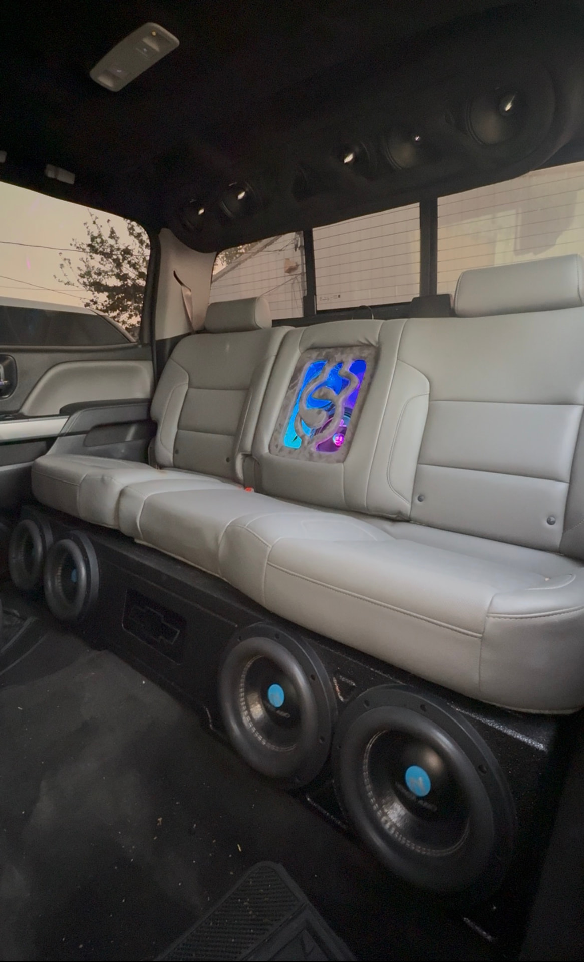 Silverado interior with roof-mounted speakers, lit seat insert and custom subwoofer bench box