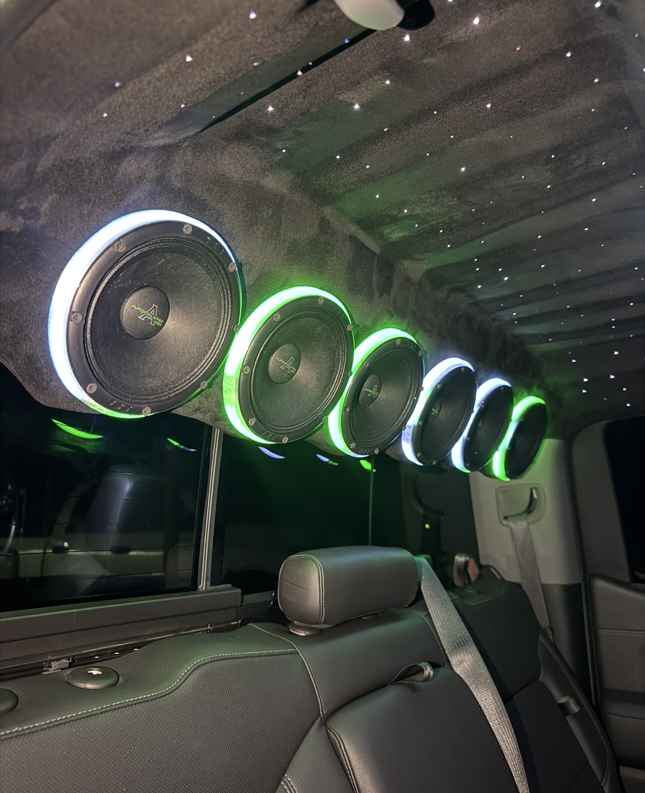 Overhead speaker rack with green LED rings and starlight headliner