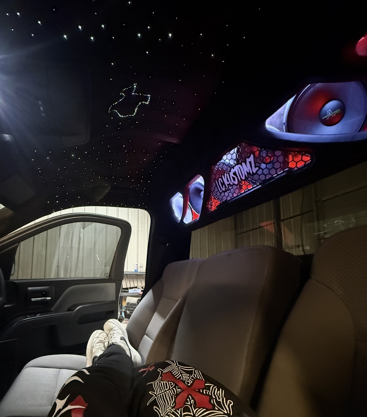 Truck cabin with Texas-shaped starlight headliner and RGB-lit honeycomb L.C KUSTOMZ panel