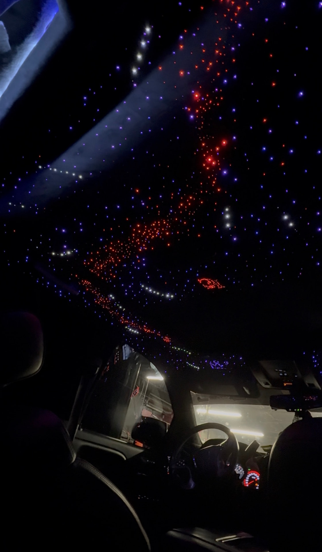 Fiber-optic starlight headliner with custom red and blue constellation designs