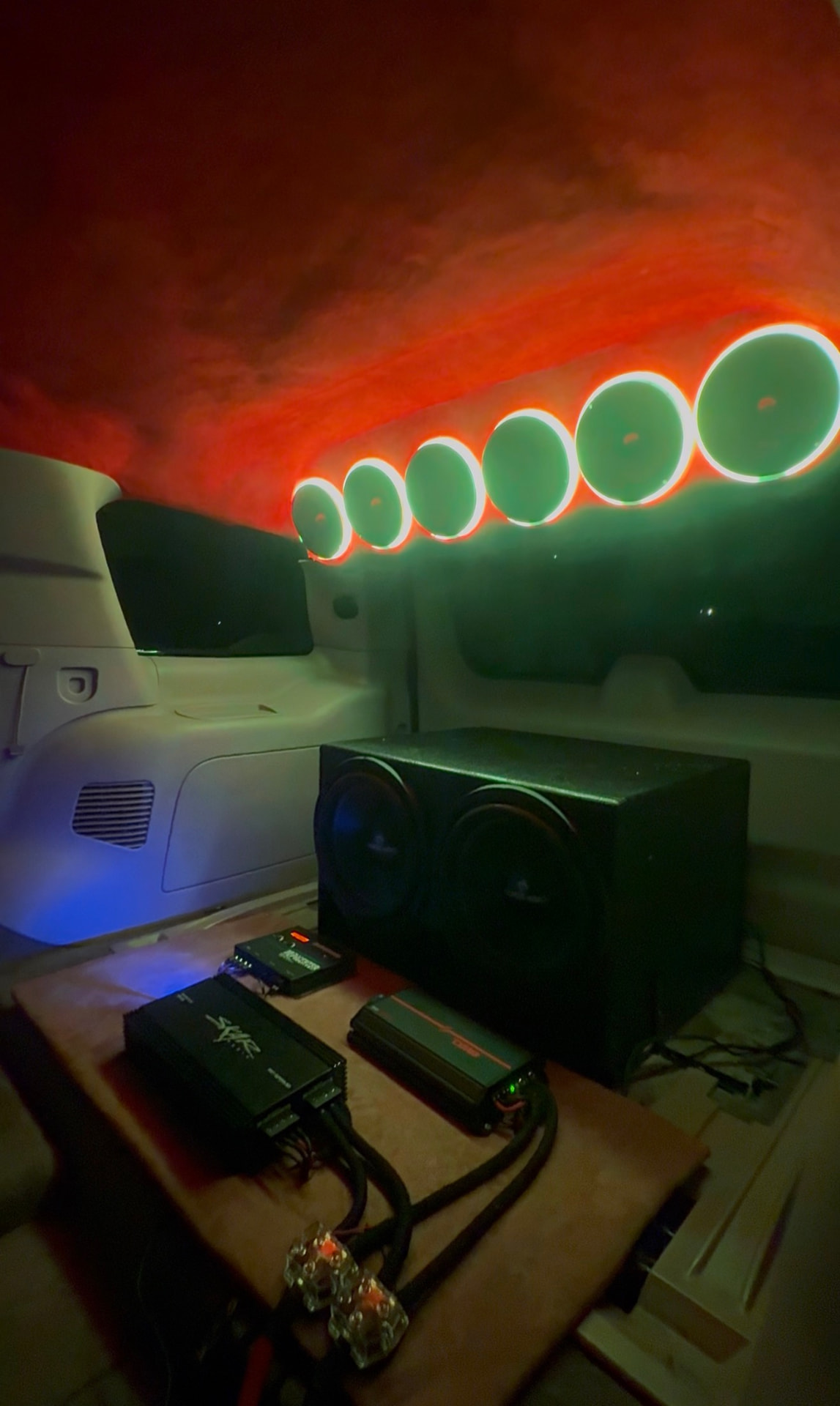 SUV with six green halo-lit overhead speakers, red starlight headliner and dual subwoofer box