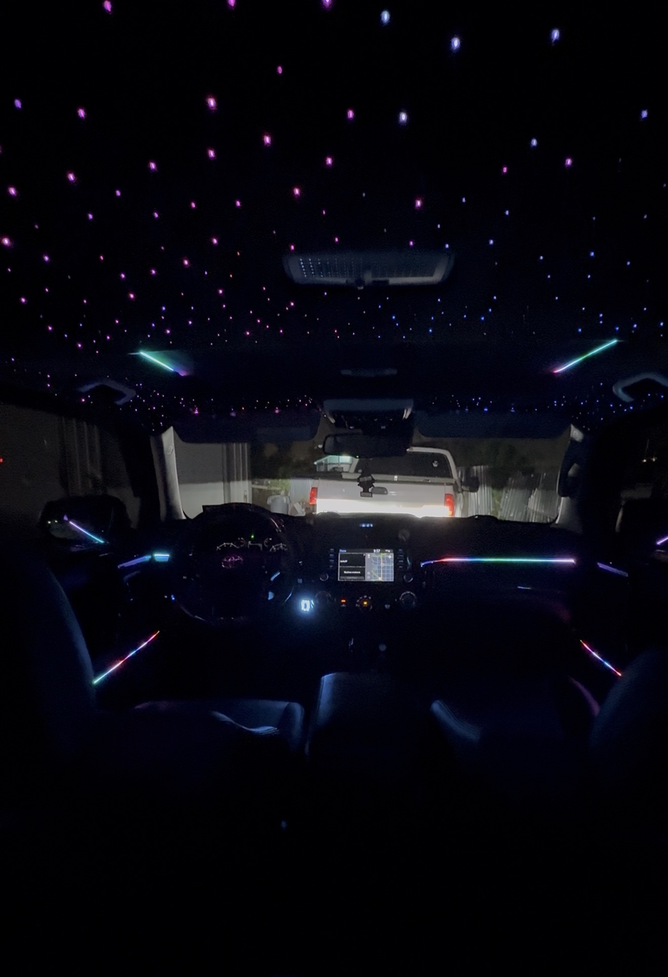Truck cabin at night with starlight headliner, shooting stars and multicolor ambient dash lighting